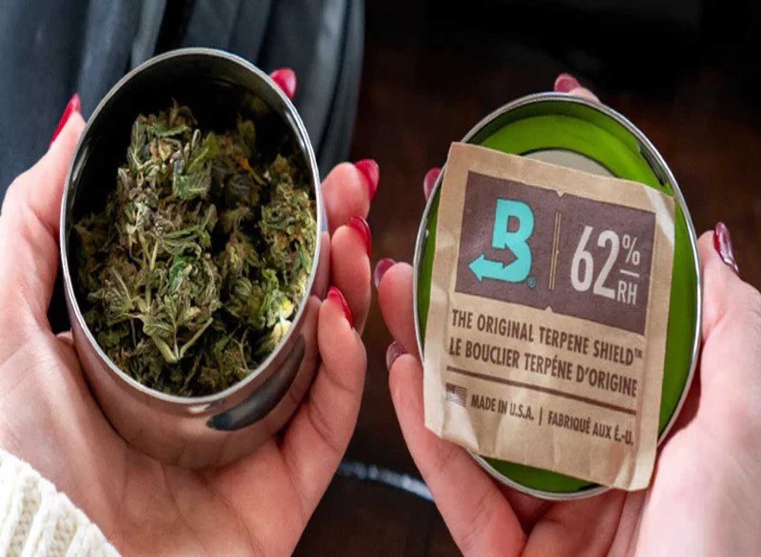 Glass jar with cannabis buds, white container, dropper bottle, and sealed packages on a teal background