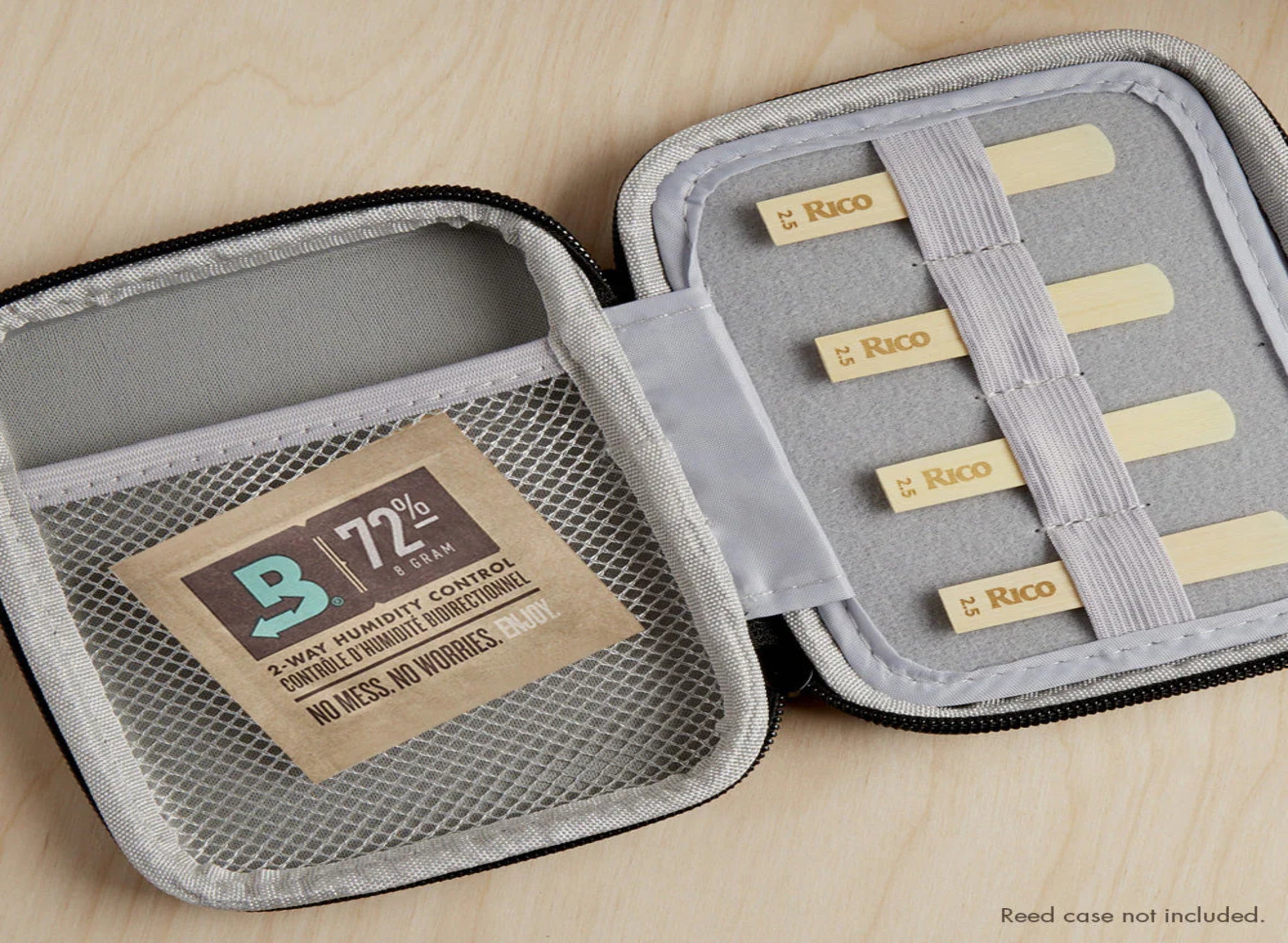 Brown paper pouch next to a cannabis bud and small pile of ground substance on a green surface