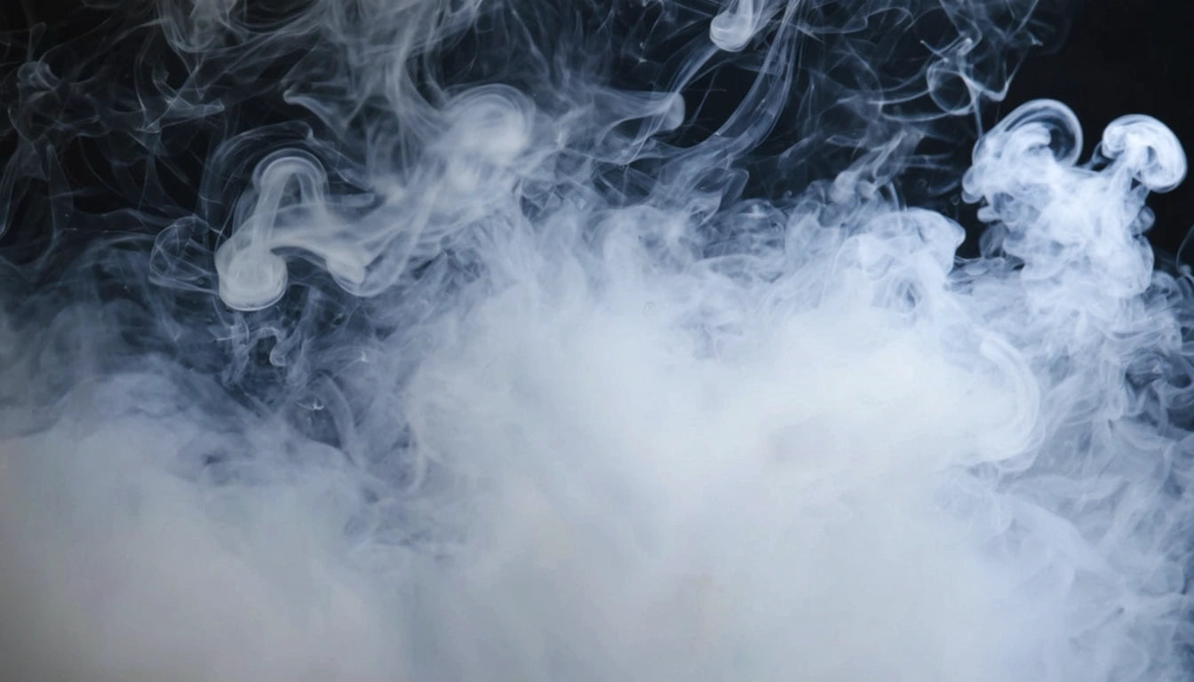 Swirling white smoke against a dark background, creating wispy patterns and curls