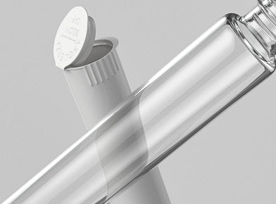 Clear glass pre-roll joint tube with plastic pre-roll tube on light gray background