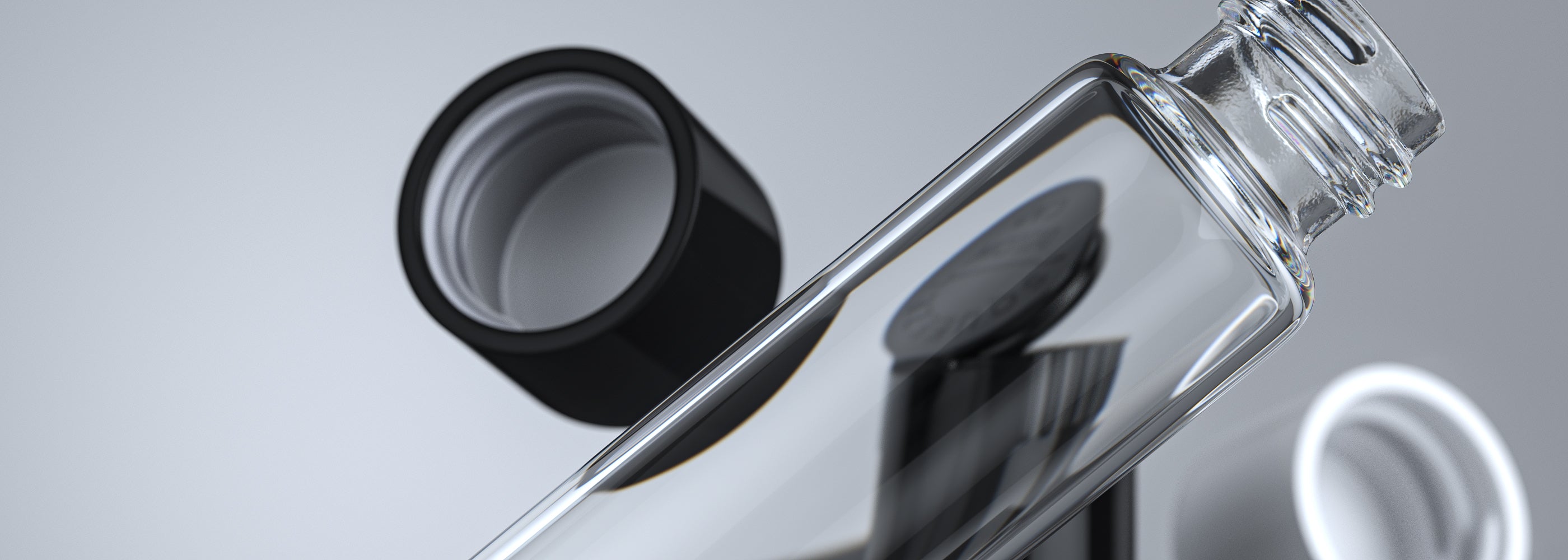 Clear glass child-resistant pre-roll tube and pop-top joint tube on light grey background