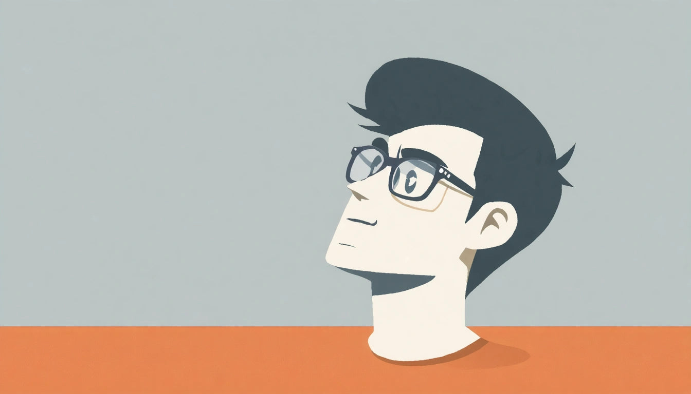 Person with glasses looking up, short dark hair, wearing an orange shirt, against a gray background