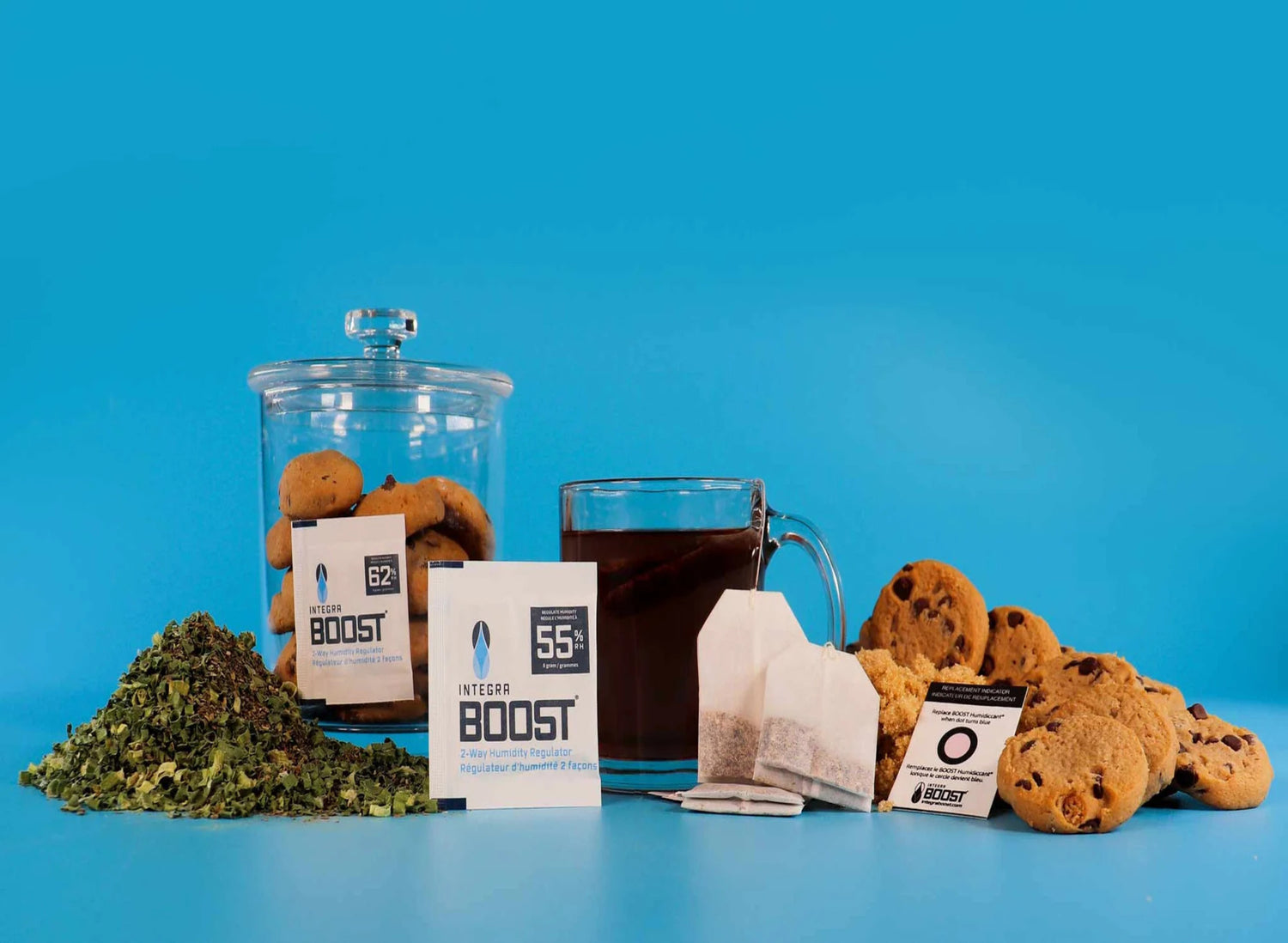 Assorted juice bottles and fresh fruits on a table, clipboard with papers, and a potted plant in the background