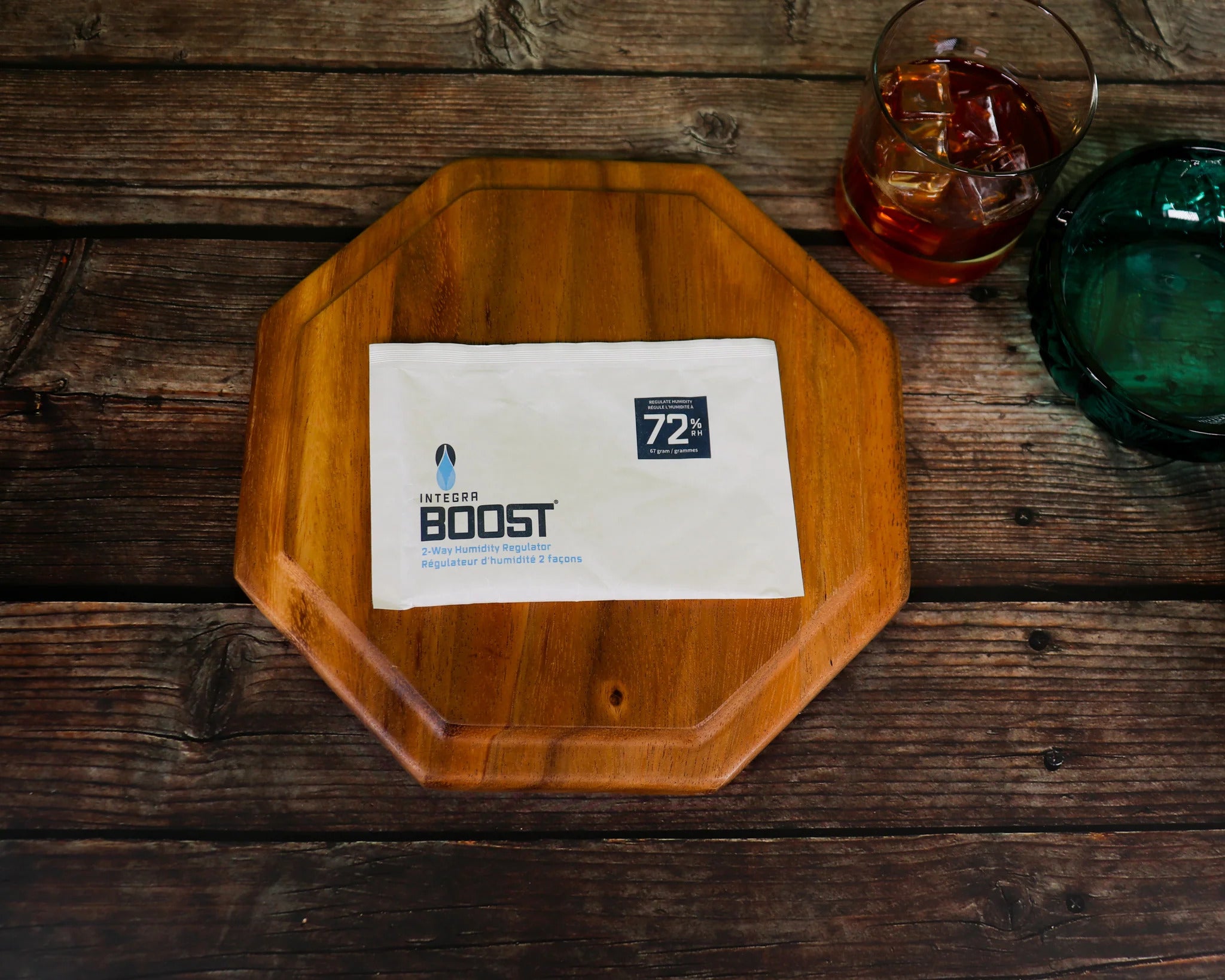 Amber dropper bottles, white pouch, and pill bottle on blue surface with cannabis buds and pills, orange gradient background