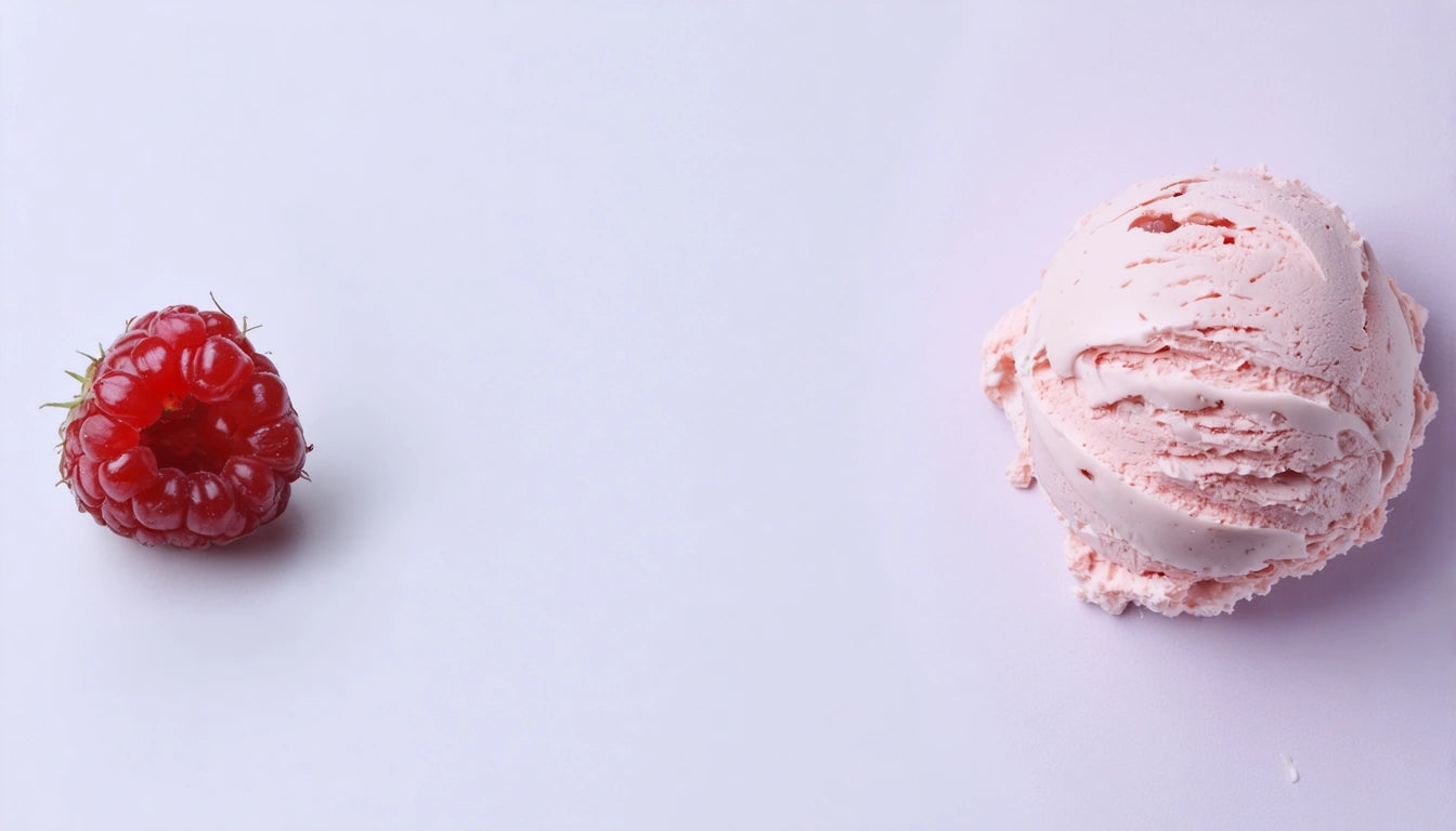 Red raspberry on left, pink ice cream scoop on right, both on a white background