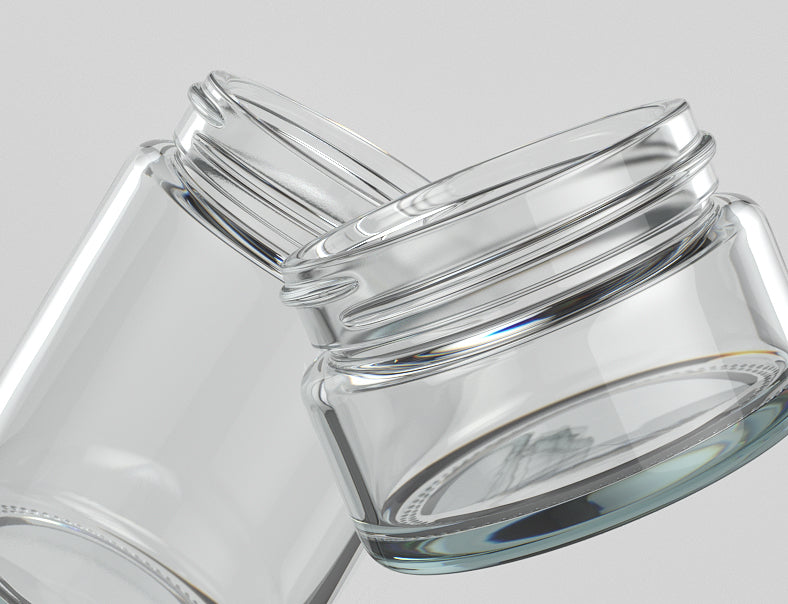 Two clear glass cannabis jars on light gray background
