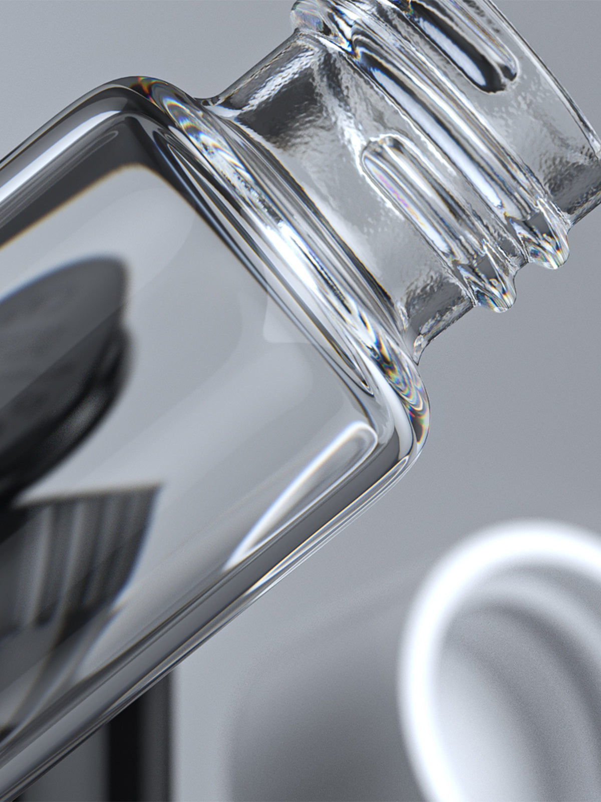 Clear glass pre-roll tube and pop-top joint tube on light grey background zoomed in